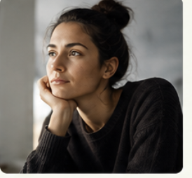 Woman reflecting beside a window